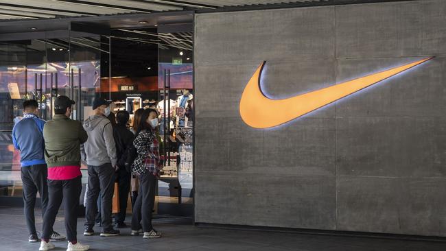 Shoppers queue outside a Beijing Nike store. Nike says first-quarter sales in China rose 5 per cent on the year despite the coronavirus crisis. Picture: Bloomberg