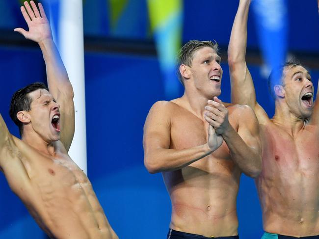 (L-R) Mitch Larkin, Jake Packard and Grant Irvine of Australia celebrate after winning the Mens 4x100m Medley Relay Final on day six of swimming competition at the XXI Commonwealth Games at Gold Coast Aquatic Centre on the Gold Coast, Australia, Tuesday, April 10, 2018. (AAP Image/Darren England) NO ARCHVIING, EDITORIAL USE ONLY