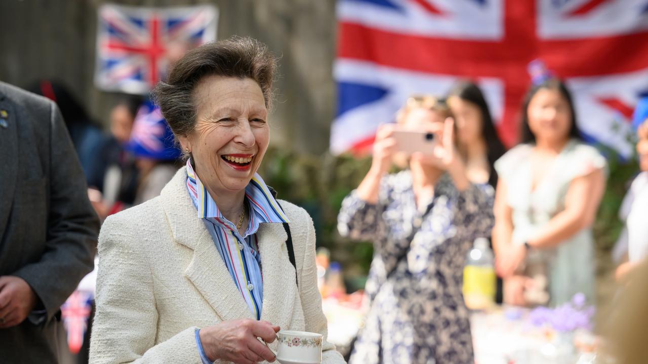 Princess Anne speaks (L) with residents of a street as they hold a Coronation street party. Picture: Getty Images