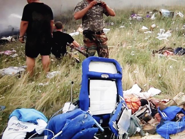 Soldiers pilfered through the MH17 site hours after the crash. Picture: News Corp Australia