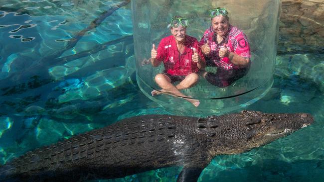 Breast cancer survivor Glenda Reid and BreastScreen NT representative Natalie Stokes entering the cage of death at the Crocosaurus Cove, Darwin. Picture: Pema Tamang Pakhrin