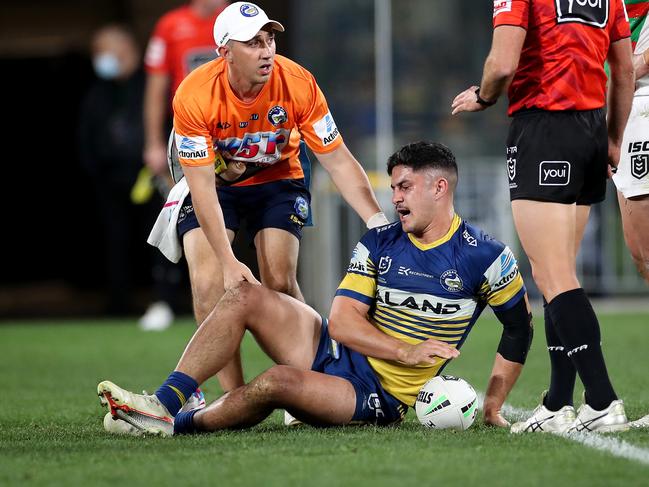 Parramatta's Dylan Brown in the hands of the trainer during NRL match between the Parramatta Eels and South Sydney Rabbitohs at Bankwest Stadium. Picture. Phil Hillyard