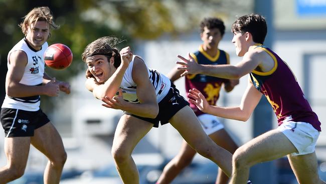 Jack Rossimel fires off a handball. Picture: Steve Tanner