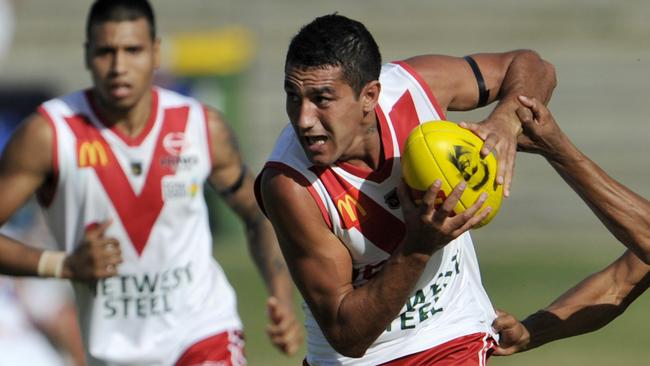 Marlion Pickett bursts through a tackle for South Fremantle as Tim Kelly watches on.