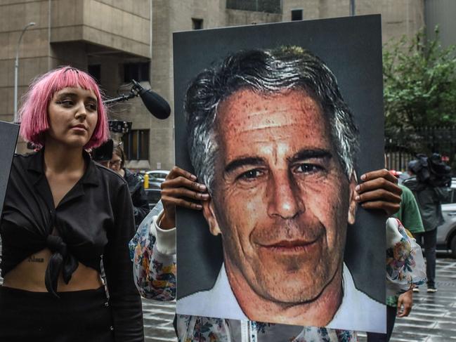 NEW YORK, NY - JULY 08: A protest group called "Hot Mess" hold up signs of Jeffrey Epstein in front of the Metropolitan Correction Center on July 8, 2019 in New York City. According to reports, Epstein will be charged with one count of sex trafficking of minors and one count of conspiracy to engage in sex trafficking of minors.   Stephanie Keith/Getty Images/AFP == FOR NEWSPAPERS, INTERNET, TELCOS & TELEVISION USE ONLY ==