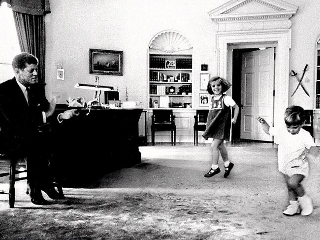 US President John F Kennedy clapping his hands as daughter Caroline, 4, and son John Jnr, 2, dance in Oval Office of the White House in Washington DC, in October, 1962.