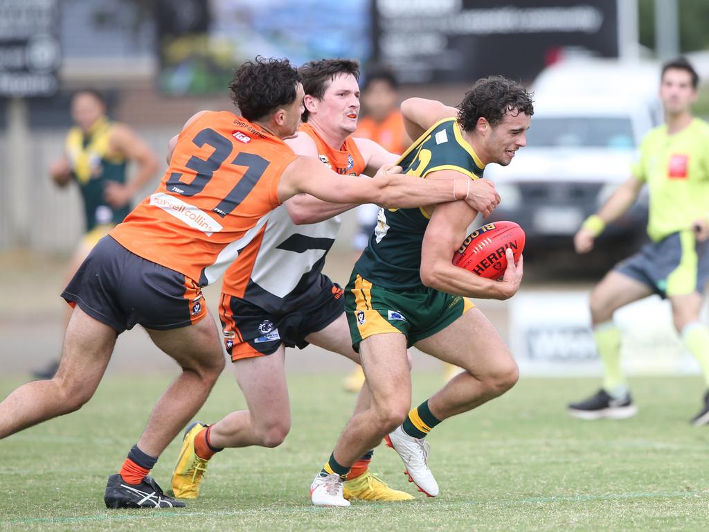 Leopold's Marcus Herbert (23) tries to break away from Giants Jake Wood (31). Leopold v Giants at Leopold. Picture: Alan Barber