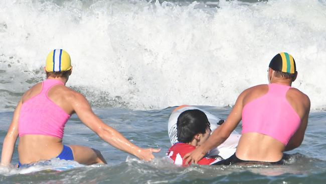 Liam Albertsen and Cooper Miskell rescue one of the Chinese visitors at Maroochydore yesterday during the championships.