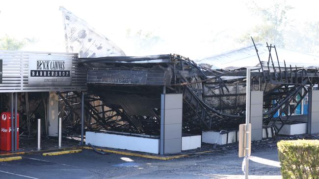 Police and firefighters at the scene of a fire at Windaroo. Pic Peter Wallis