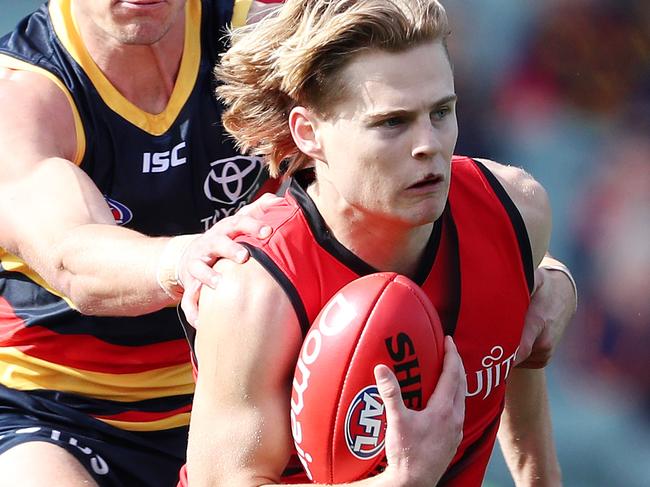 AFL - Sunday, 26th July, 2020 - Adelaide Crows v Essendon at the Adelaide Oval. Essendon's Ned Cahill under pressure from Adelaide's Ben Keays Picture: Sarah Reed