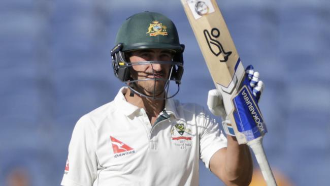 Australia's Mitchell Starc celebrates his fifty against India.