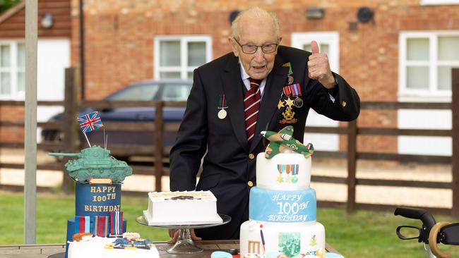 Captain Tom Moore posing for a photograph with cakes to celebrate his 100th birthday in Marston Moretaine, north of London.