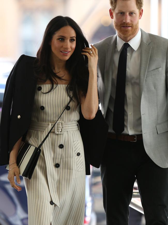 Meghan Markle wore a $699 Camilla and Marc blazer over her shoulders and accessorised with an $312 Oroton bag. Picture: Getty Images.