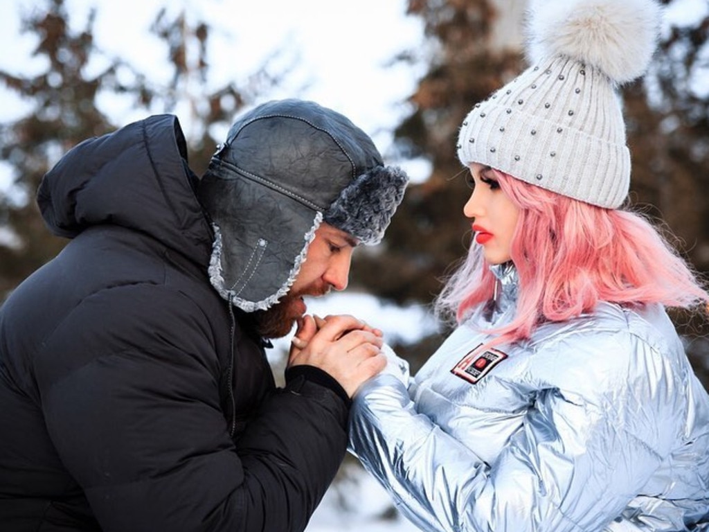 Yuri warms Margo's hands in the snow.