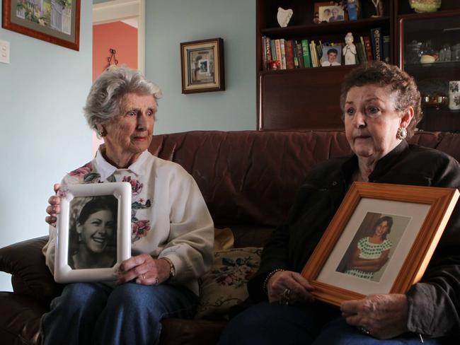Beth Leen (left) with a photo of her daughter Leanne Goodall, and Anne Robinson with a photo of her daughter Amanda Robinson, both girls who went missing in the Hunter Region.