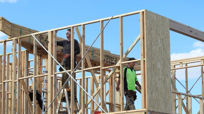 Labourers work at a housing estate at Deer Park in the outer western suburbs of Melbourne. Picture: David Crosling