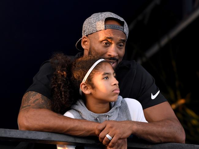 Kobe Bryant and daughter Gianna Bryant watch during day 2 of the Phillips 66 National Swimming Championships at the Woollett Aquatics Center on July 26, 2018 in Irvine, California. Picture: Getty