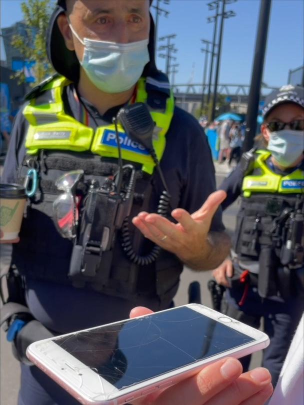 Senior Constable Rick Barry from Victoria Police explains the Australian Open's rules regarding political statements to a protester.