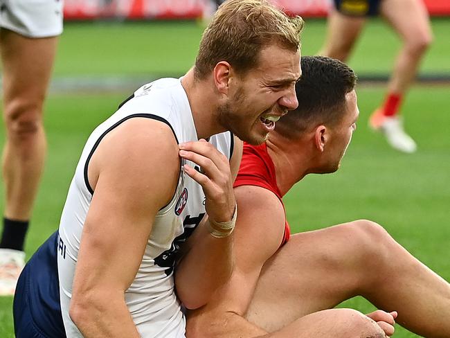 MELBOURNE, AUSTRALIA - MAY 16: Harry McKay of the Blues grabs at his shoulder during the round 9 AFL match between the Melbourne Demons and the Carlton Blues at Melbourne Cricket Ground on May 16, 2021 in Melbourne, Australia. (Photo by Quinn Rooney/Getty Images)