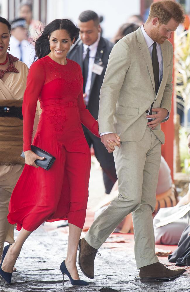 Meghan wearing a red dress by British label Self-Portrait. Picture: Dominic Lipinski/Pool Photo via AP, File