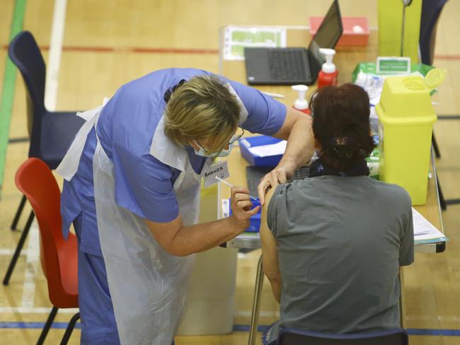 A member of the public receives a dose of the Oxford/AstraZeneca vaccine at the vaccination centre at Cwmbran Stadium in Wales. Picture: Getty Images