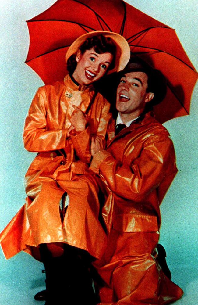 Teenage Reynolds and co-star Gene Kelly in their wet-weather gear for Singin’ in the Rain. Picture: Supplied