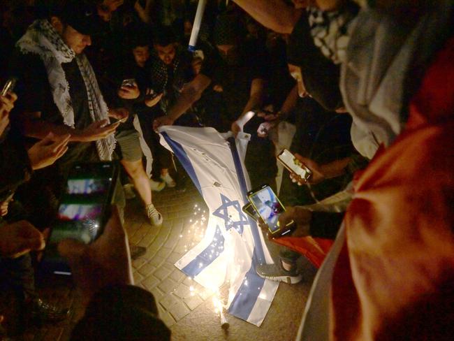 SYDNEY, AUSTRALIA - NewsWire Photos OCTOBER 9, 2023: ÃRally For A Free PalestineÃ protest burn the Israeli flag on the forecourt of The Sydney Opera House  in Sydney following the recent outbreak of war between Israel and Palestine.Picture: NCA NewsWire / Jeremy Piper