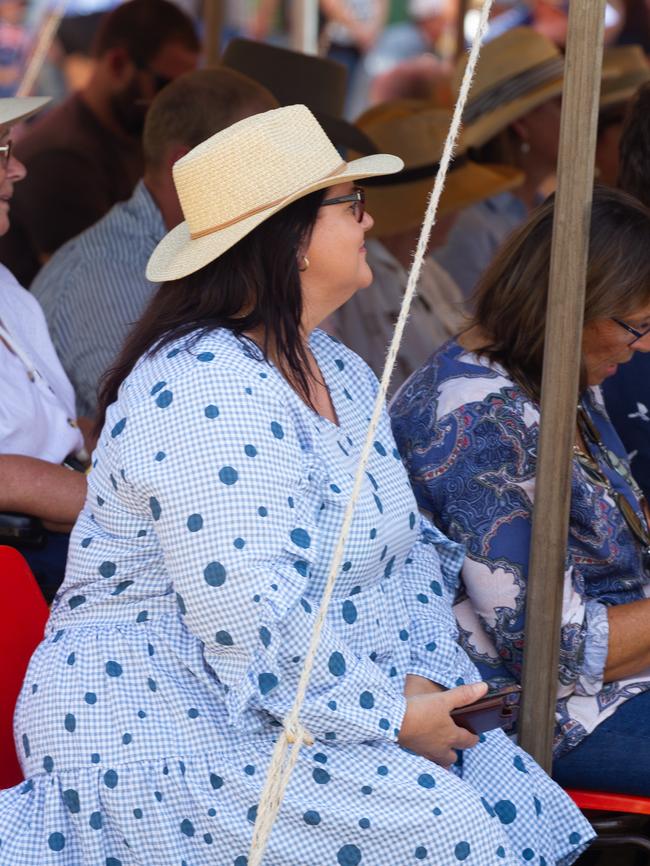 Guests sat under the cool shade of the tents during the hot summer day.