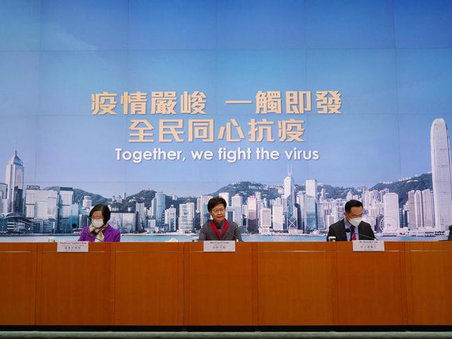 Hong Kong's Chief Executive Carrie Lam (C), Secretary for Food and Health Sophia Chan (left),and Director of Health Ronald Lam, hold a press conference as the city's government announces strict new anti-coronavirus controls on January 5, 2022. Picture: Daniel Suen / AFP.