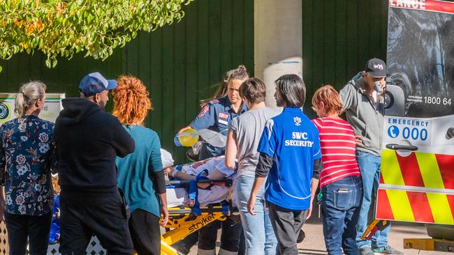 Paramedics treat a person who is suspected of overdosing at the injecting room. Picture: Jason Edwards