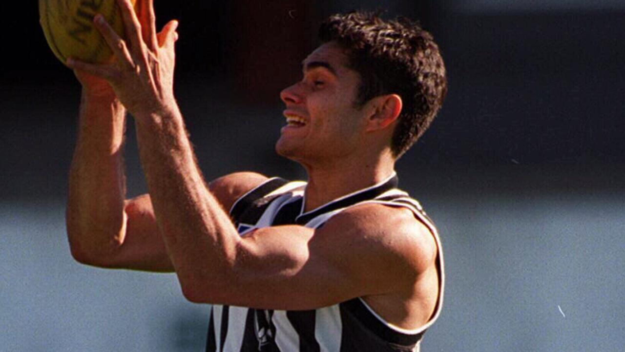 JUNE 4, 1999 : Mal Michael flies high over teammate at Collingwood AFL training at Victoria Park, 04/06/99. Pic Richard Cisar-Wright Australian Rules