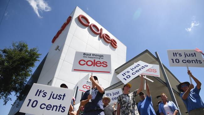 Queensland dairy farmers protest outside a Coles supermarket store in Brisbane. Picture: AAP