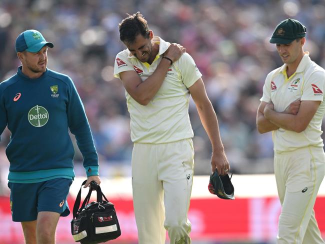 Mitchell Starc leaves the field clutching at his shoulder. Picture: Getty Images