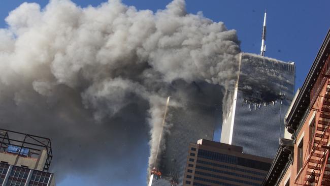 FILE - In this Sept. 11, 2001 file photo, smoke rising from the burning twin towers of the World Trade Center after hijacked planes crashed into the towers, in New York City. Every American of a certain age has a 9/11 story _ vivid memories of where they were, what they saw, how they felt on that awful day. Donald Trump is one of them. And for New Yorkers like him, 9/11 melds first-hand experience with what they felt in their guts, what they saw on television and what was playing out in the lives of friends and loved ones in a city under siege. (AP Photo/Richard Drew, File)