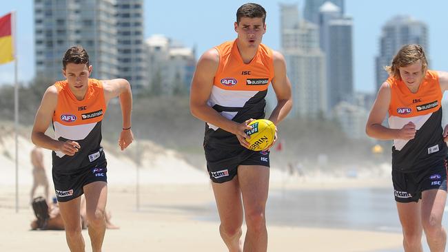 (from left) Josh Kelly, Tom Boyd and Cam McCarthy at Kurrawa Beach on the Gold Coast after being drafted to the Giants in 2013. Picture: Getty Images