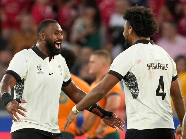 Fiji's Isoa Nasilasila (R) and Temo Mayanavanua (L) celebrate victory. Picture: Francis BOMPARD / AFP