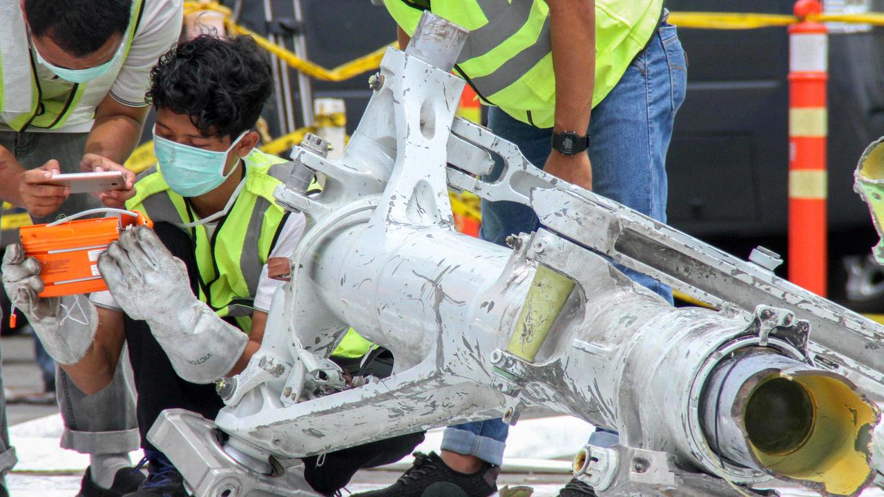 Lion Air investigators examine part of the landing gear of the ill-fated Lion Air flight JT 610 at the port in northern Jakarta. All 189 passengers died. Picture: Azwar Ipank / AFP