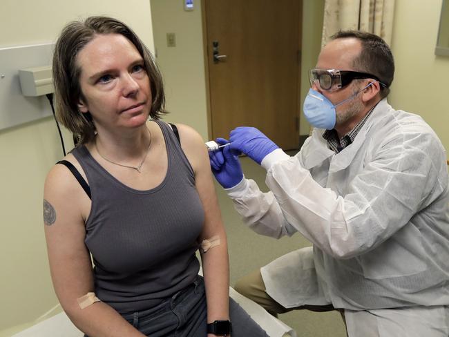 Jennifer Haller, left, receives the first shot in the first-stage safety study clinical trial of a potential vaccine for COVID-19 developed by Moderna. Picture: AP