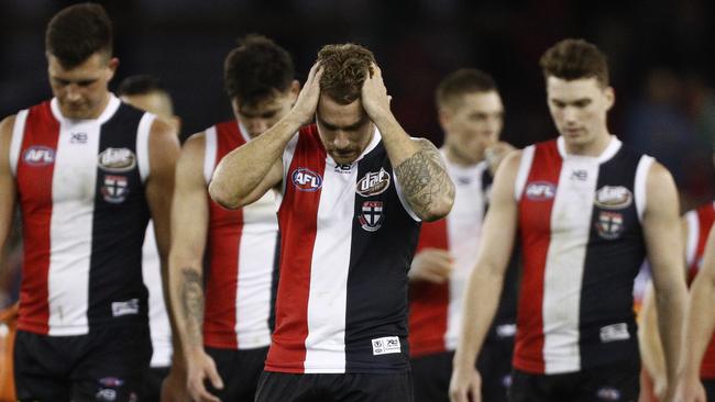 Dejected St Kilda players leave the field after their loss to Brisbane Lions. Picture: AAP Image/Daniel Pockett.