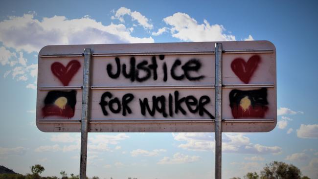 Signs on the Tanami Road to Yuendumu in memory of Kumanjayi Walker. Picture: Jason Walls