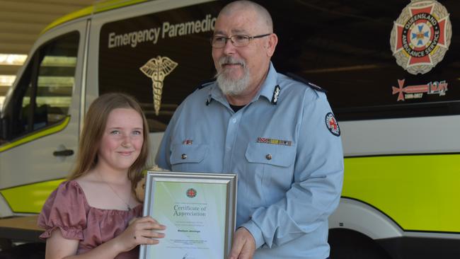 Madison Jennings with QAS Central Region Assistant Commissioner Robbie Medlin. Picture: Lillian Watkins