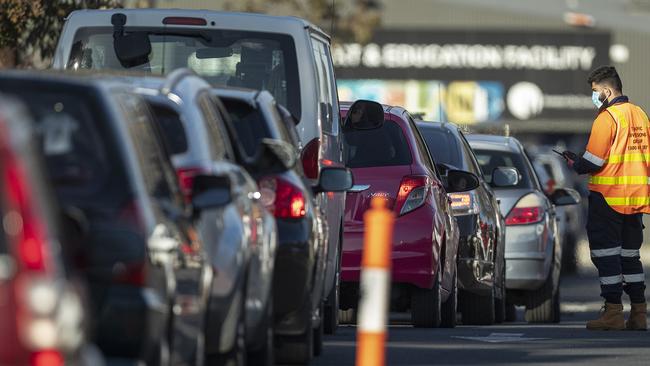 Staff direct traffic in massive queues waiting to get into a pop-up COVID-19 test site in Fawkner on Wednesday. Picture: Daniel Pockett/Getty