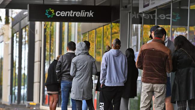 People queue up outside a Centrelink office for JobKeeper payments. Picture: William West/AFP