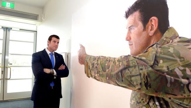 Mr Roberts-Smith examines a portrait of himself at the Australian War Memorial in Canberra. Picture: AAP