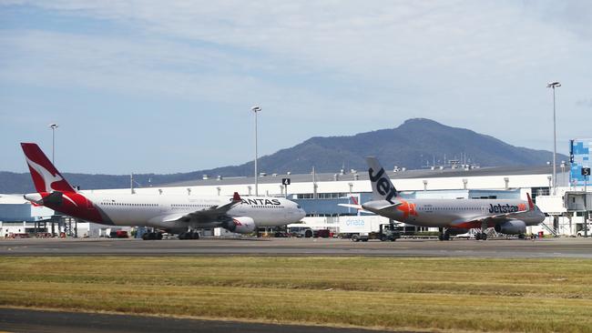 A Qantas Airbus A330 and a Jetstar Airbus A320 wide body passenger jet aircraft sit on the tarmac at the Cairns Airport international terminal. Picture: Brendan Radke