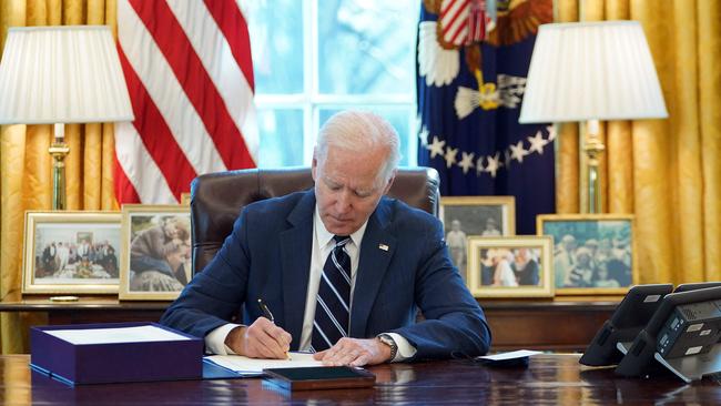 Joe Biden signs the American Rescue Plan on March 11, 2021, in the Oval Office of the White House in Washington, DC. Picture: AFP