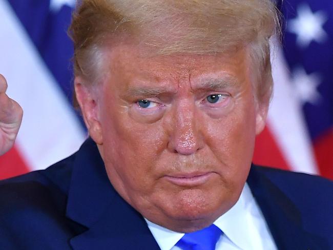 TOPSHOT - US President Donald Trump pumps his fist after speaking during election night in the East Room of the White House in Washington, DC, early on November 4, 2020. (Photo by MANDEL NGAN / AFP)