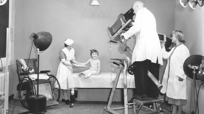 Medical photographer Cyril Murphy photographing a patient prior to discharge at the Royal Children’s Hospital in Carlton; 1959. Picture: Laurie Richards Studio/Royal Children’s Hospital Archives