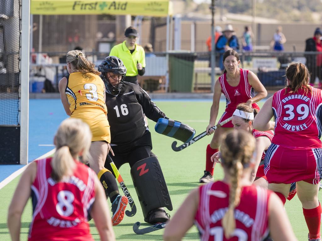 Bundaberg 1 goal keeper Christine Pohlmann defends against Sunshine Coast 1.