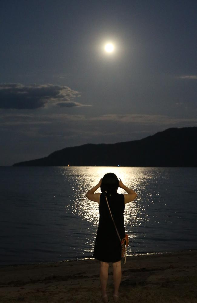 A tourist in Cairns snaps the moon which is 30 per cent brighter than usual. Picture: JUSTIN BRIERTY